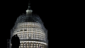 Capitol building under scaffolding at night