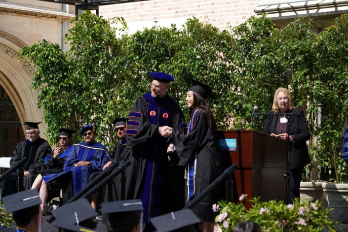 Professor Okin shaking graduate's hand