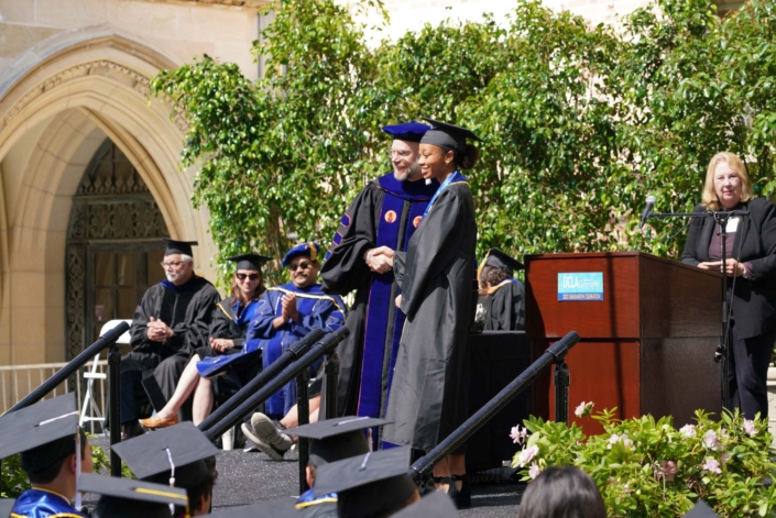 Professor Okin shaking graduate's hand